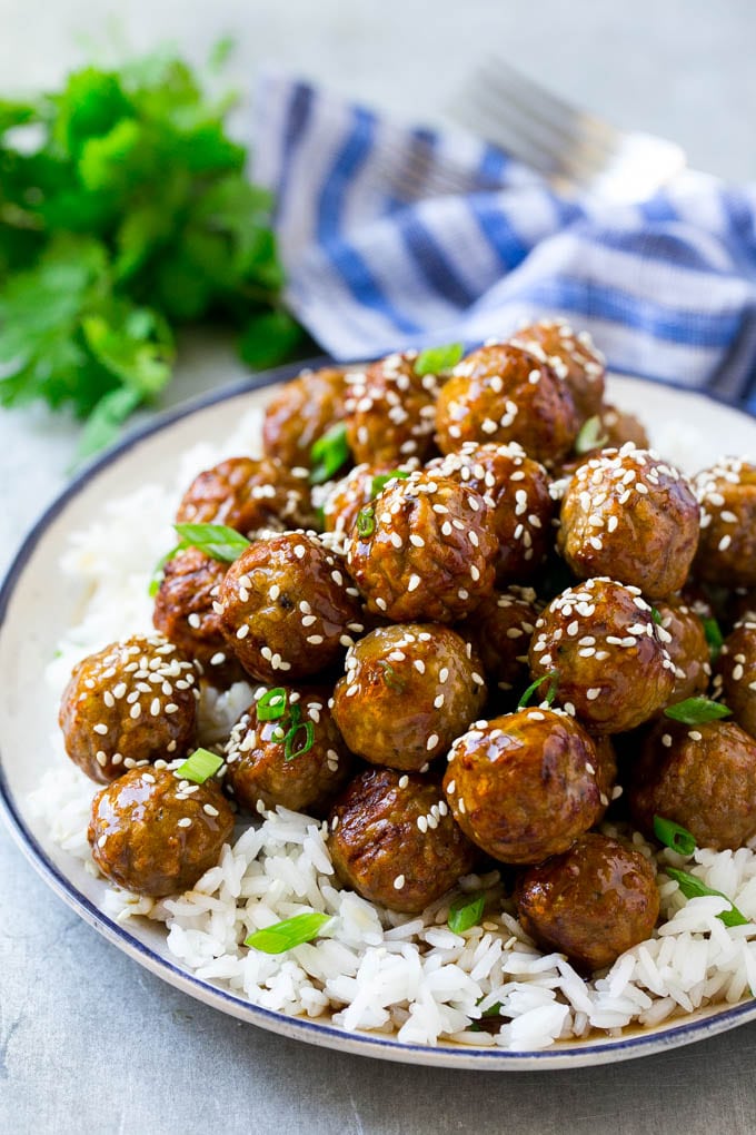 Teriyaki Meatballs Recipe | Asian Meatballs Recipe | Easy Meatball Recipe | Appetizer Meatballs #meatballs #teriyaki #beef #rice #dinner #sadud Teriyaki meatballs served over a bed of steamed rice and garnished with sesame seeds.