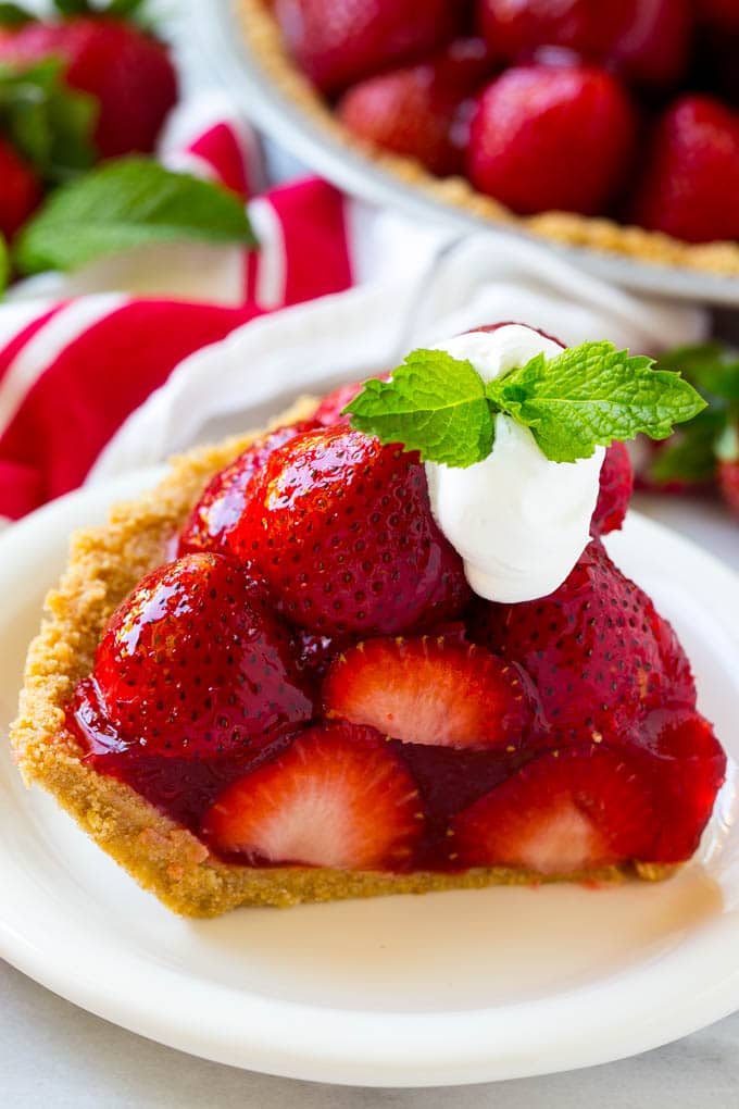 No Bake Strawberry Pie Recipe | Fresh Strawberry Pie | Strawberry Pie Recipe | No Bake Pie Recipe #strawberry #strawberrypie #nobake #nobakepie #dessert #sadud A slice of no bake fresh strawberry pie with whipped cream on top.