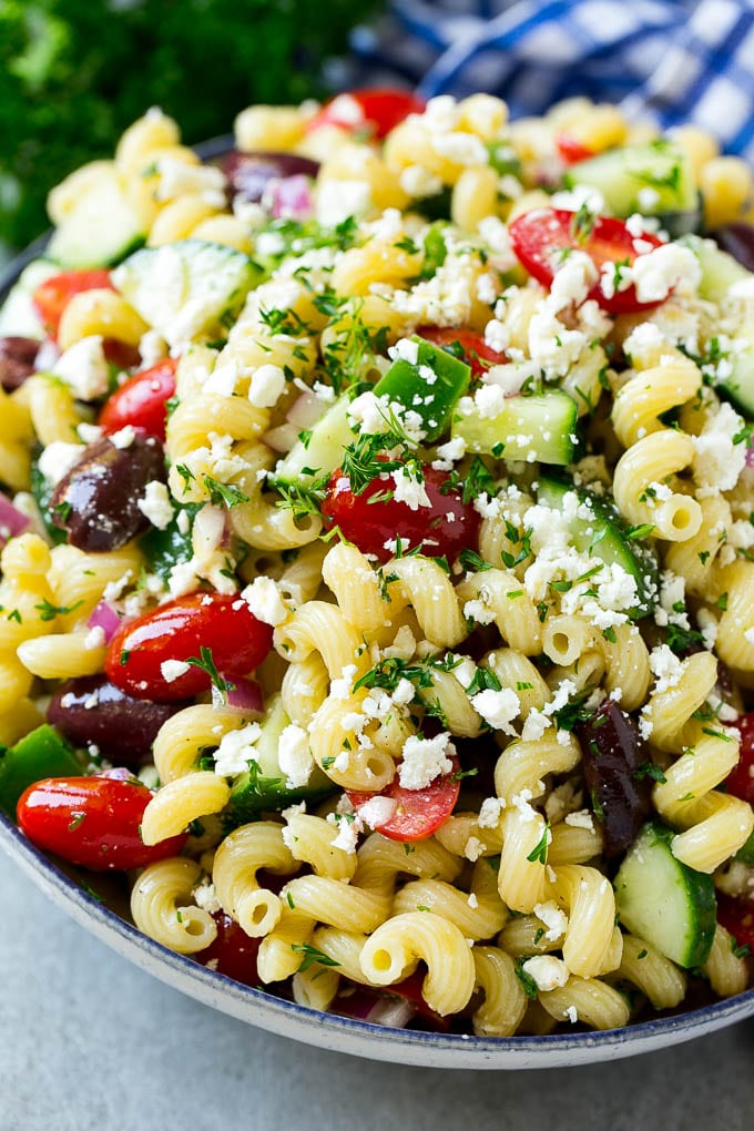 Greek Pasta Salad | Easy Pasta Salad | Vegetable Pasta Salad #pasta #salad #greek #cucumber #tomato #vegetarian #dinner #sadud A bowl of Greek pasta salad loaded with feta cheese, olives, tomatoes, cucumber and bell peppers.