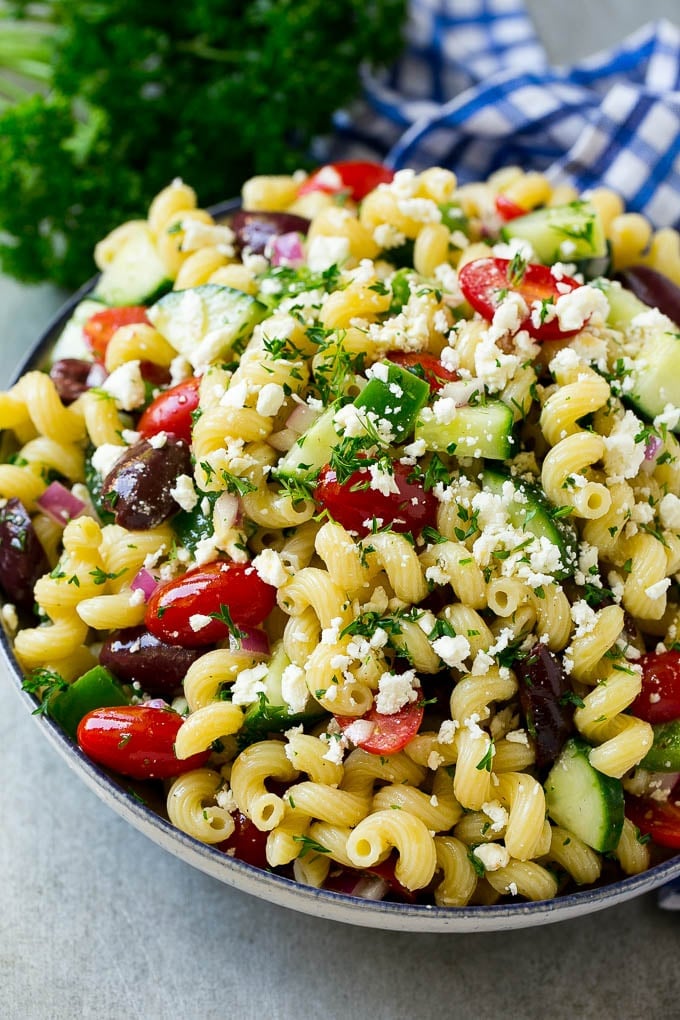 Greek Pasta Salad | Easy Pasta Salad | Vegetable Pasta Salad #pasta #salad #greek #cucumber #tomato #vegetarian #dinner #sadud Greek pasta salad in a serving bowl, garnished with parsley.