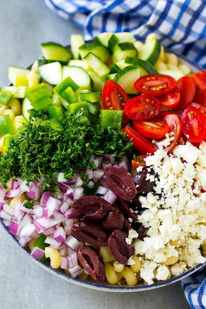 Greek Pasta Salad | Easy Pasta Salad | Vegetable Pasta Salad #pasta #salad #greek #cucumber #tomato #vegetarian #dinner #sadud Cherry tomatoes, bell pepper, olives, feta, herbs and cucumbers over pasta.