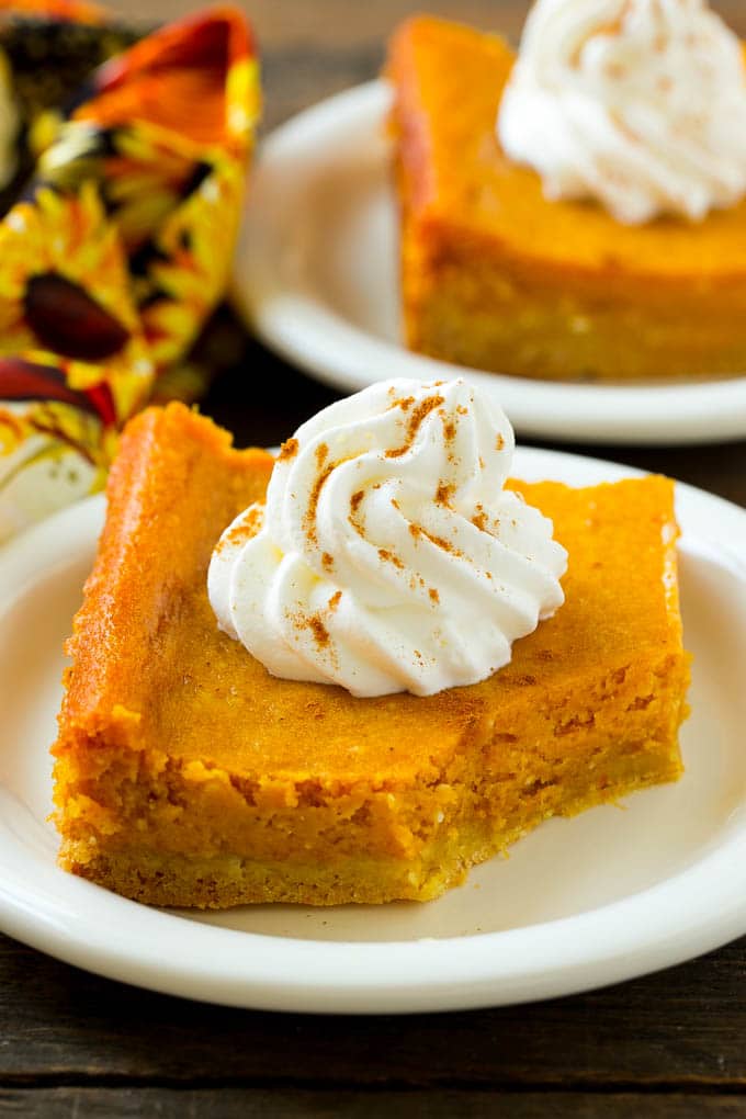 Pumpkin Gooey Butter Cake Recipe | Pumpkin Cake Recipe | Gooey Butter Cake | Pumpkin Dessert | Thanksgiving Dessert #pumpkin #cake #pumpkincake #gooeybuttercake #dessert #sadud A slice of pumpkin butter cake with a bite taken out of it.