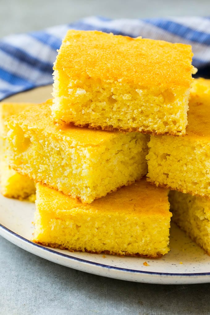 Honey Cornbread Recipe | Buttermilk Cornbread | Easy Cornbread | Homemade Cornbread | Cast Iron Cornbread #cornbread #honey #buttermilk #bread #sadud A plate full of squares of bread made with cornmeal.