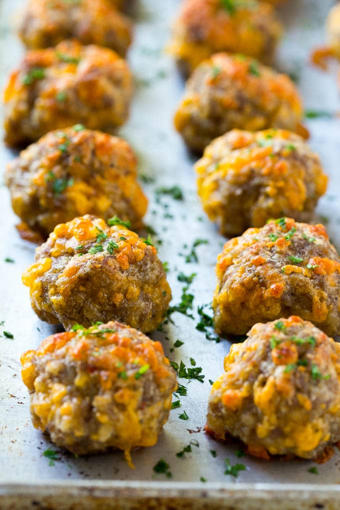 Sausage Cheese Balls Recipe | Sausage Balls Recipe | Bisquick Sausage Balls #sausage #sausageballs #balls #appetizer #cheeseballs #sadud Cooked meatballs on a baking sheet.