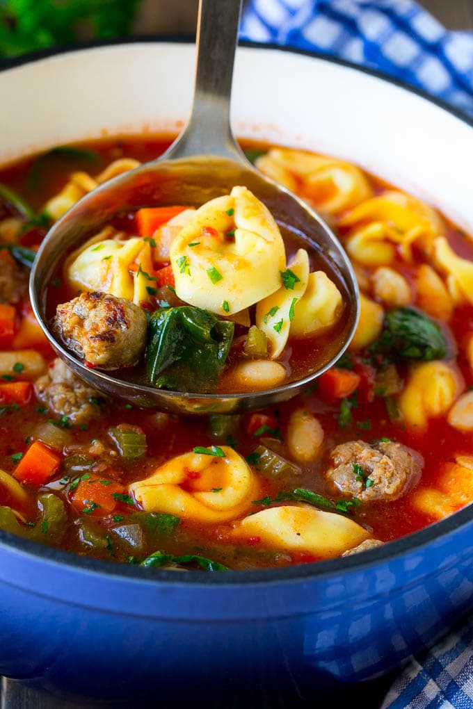 Tortellini Soup Recipe | Sausage Soup | Italian Soup #soup #sausage #pasta #tortellini #dinner #sadud A ladle serving up a portion of tortellini soup.