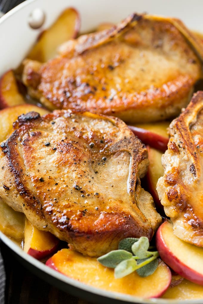 Apple Pork Chops Recipe | Pork Chops with Apples | Cider Pork Chops | Bone In Pork Chops Recipe #pork #porkchops #fall #apple #dinner #sadud Seared pork in a pan in a sweet and savory sauce with fresh herbs.