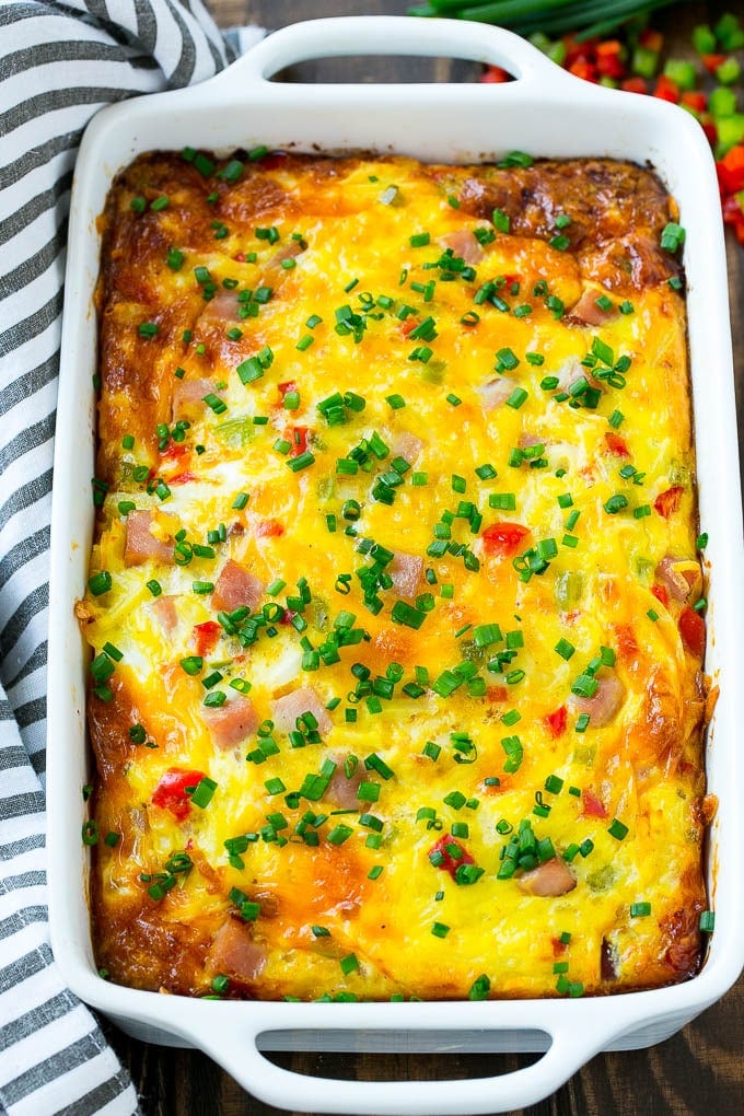 Hash Brown Egg Casserole Recipe | Breakfast Casserole with Ham | Hash Brown Casserole | Ham and Egg Casserole | Egg Casserole with Ham #casserole #breakfast #eggs #egg #hashbrown #sadud Hash brown egg casserole in a white baking dish.