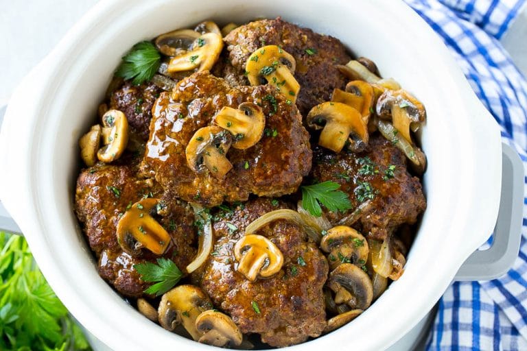 Slow Cooker Salisbury Steak Recipe | Homemade Salisbury Steak | Salisbury Steak from Scratch #steak #beef #salisbury #salisburysteak #slowcooker #crockpot #dinner #sadud A crock pot full of slow cooker salisbury steak.