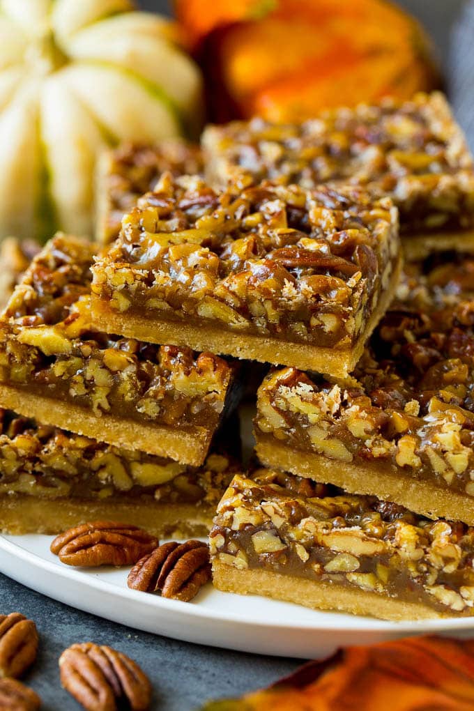 Pecan Pie Bars Recipe #pecans #pie #fall #pecanpie #dessert #thanksgiving #sadud A serving platter full of pecan pie bars.
