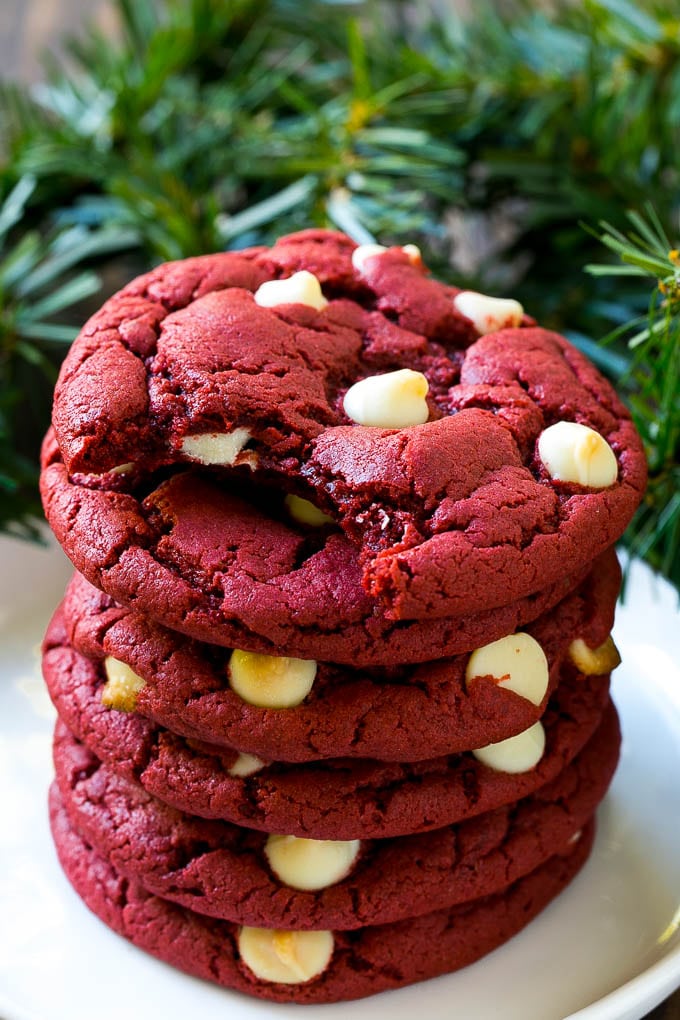 Red Velvet Cookies Recipe | Red Velvet Cookies with White Chocolate Chips | Red Velvet Cake Mix Cookies #redvelvet #cookies #whitechocolate #christmas #sadud A stack of red velvet cookies on a plate.