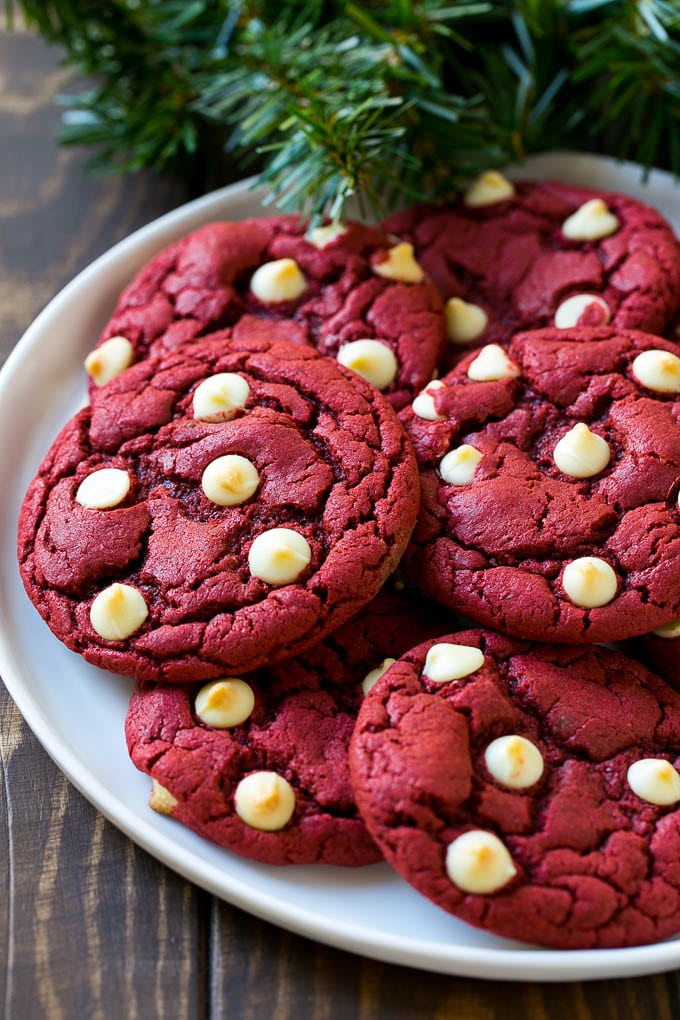 Red Velvet Cookies Recipe | Red Velvet Cookies with White Chocolate Chips | Red Velvet Cake Mix Cookies #redvelvet #cookies #whitechocolate #christmas #sadud Red Velvet Cookies on a serving plate with holiday decorations nearby,