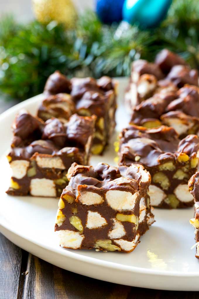 Rocky Road Fudge | Chocolate Marshmallow Fudge | Chocolate Nut Fudge | Microwave Fudge #fudge #chocolatefudge #nobake #chocolate #dessert #rockyroad #sadud Squares of rocky road fudge on a serving plate.