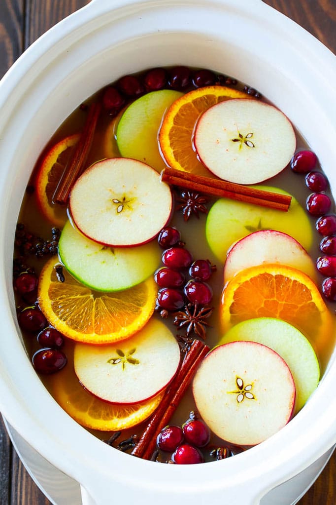 Slow Cooker Apple Cider | Mulled Apple Cider | Crockpot Apple Cider #cider #apple #applecider #drink #crockpot #slowcooker #sadud Slow cooker apple cider garnished with apple slices, oranges, cranberries, cinnamon sticks and spices.