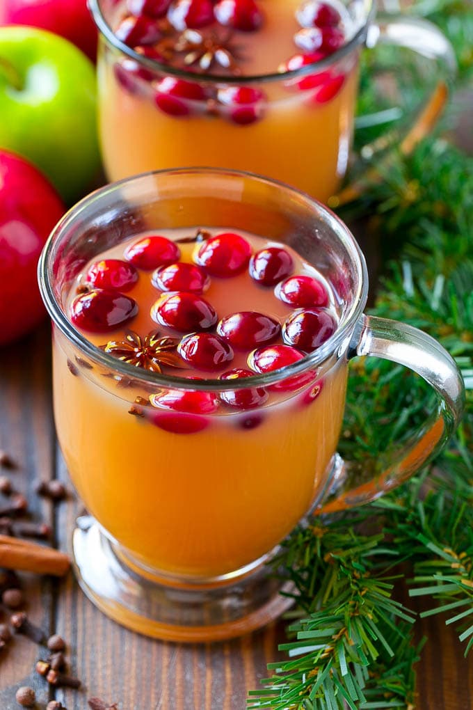 Slow Cooker Apple Cider | Mulled Apple Cider | Crockpot Apple Cider #cider #apple #applecider #drink #crockpot #slowcooker #sadud Mugs of slow cooker apple cider garnished with cranberries.