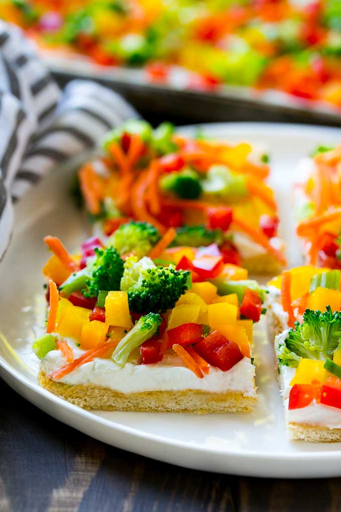 Veggie Pizza Recipe | Crescent Veggie Pizza | Vegetable Pizza Recipe | Holiday Appetizer | Homemade Veggie Pizza #pizza #veggies #vegetarian #appetizer #sadud Slices of veggie pizza on a serving plate.
