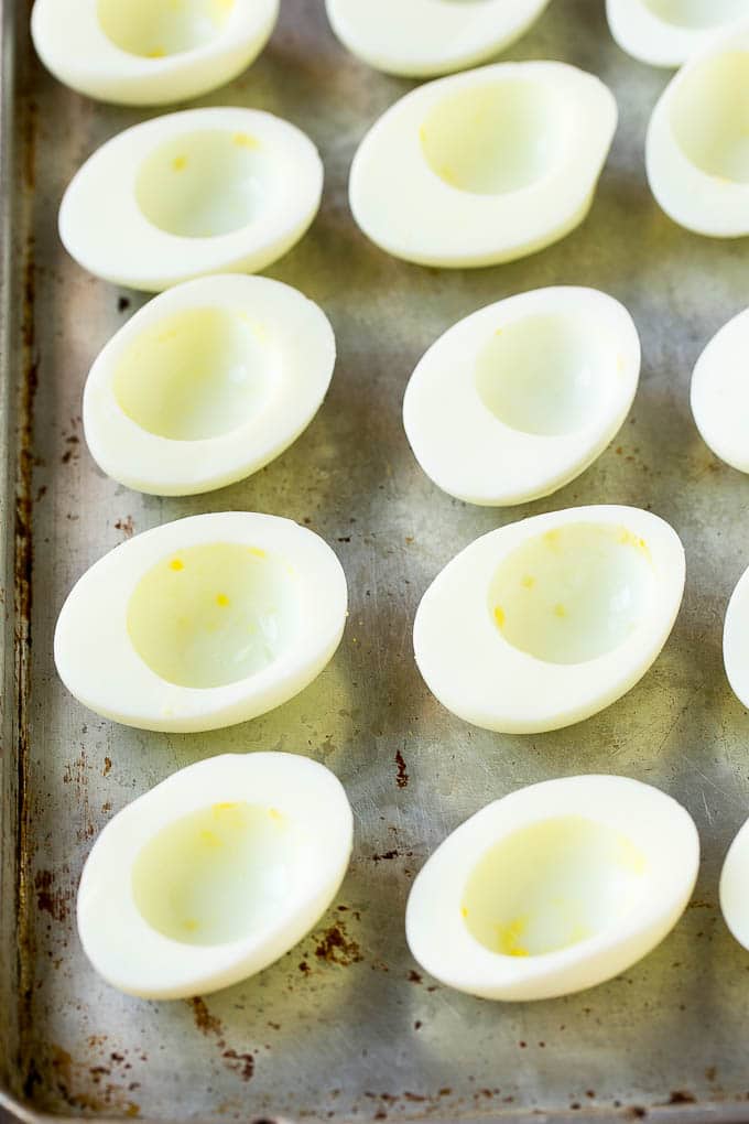 Bacon Deviled Eggs | Deviled Eggs Recipe #eggs #keto #lowcarb #bacon #appetizer #sadud Egg white halves on a sheet pan.