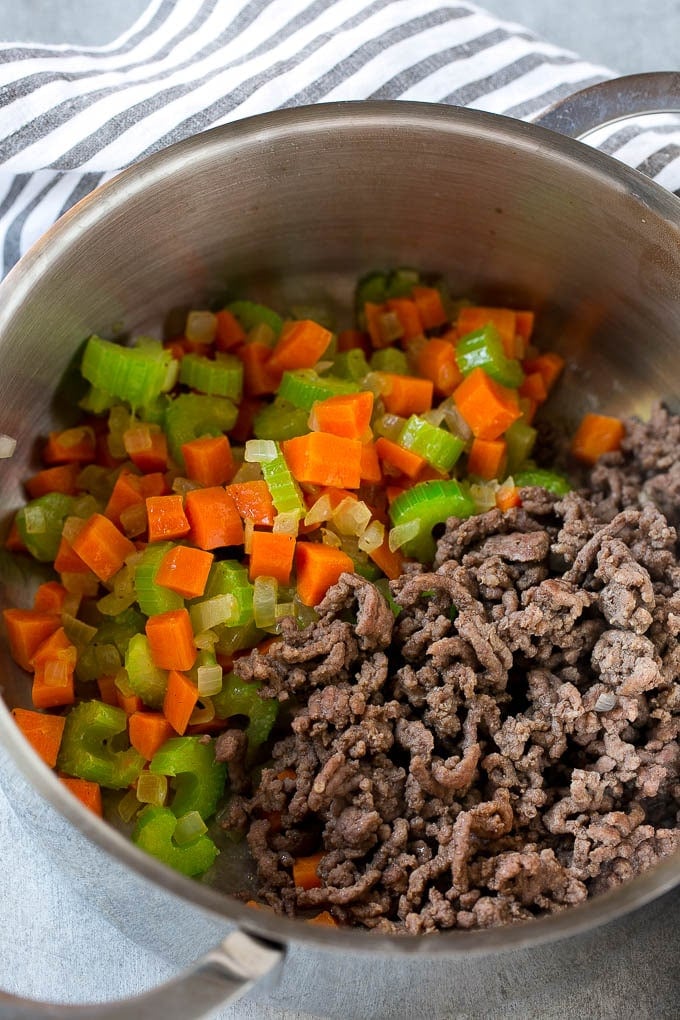 Hamburger Soup Recipe | Hamburger Stew | Ground Beef Soup #hamburger #soup #groundbeef #stew #dinner #sadud Ground beef is added to the vegetables in a pot.