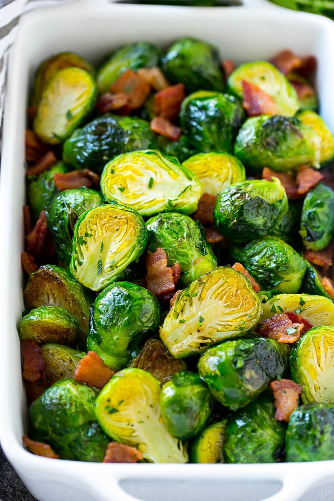 These bacon roasted brussels sprouts are crispy on the outside, soft on the inside and full of smoky flavor. A dish of bacon roasted brussels sprouts with parsley.
