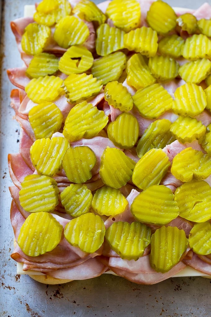 Cuban Sliders Recipe | Cuban Sandwich Recipe | Slider Sandwiches | Ham and Cheese Sliders #sliders #sandwiches #ham #cheese #appetizer #sadud Bread layered with cheese, ham and pickles.