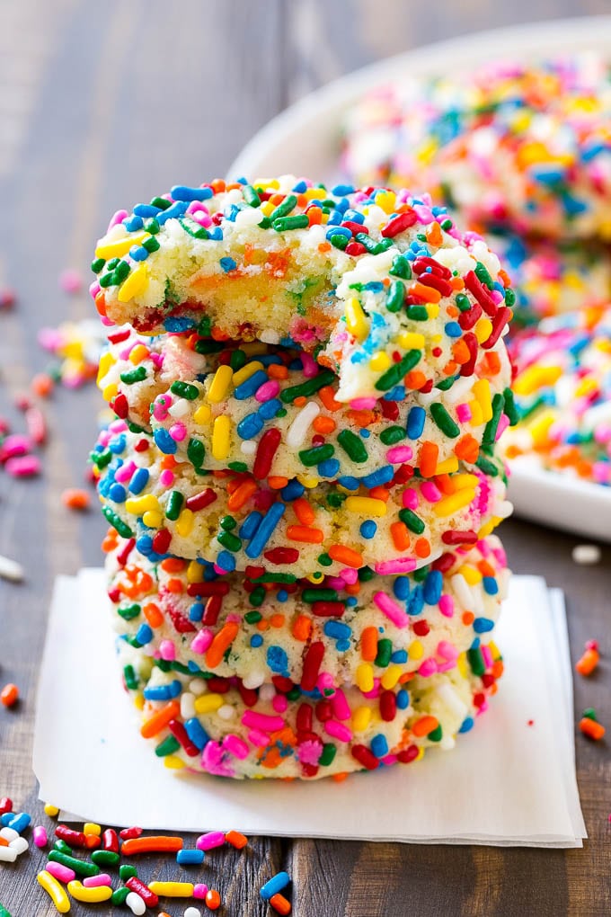 Funfetti Cookies Recipe | Funfetti Cake Mix Cookies | Sprinkle Cookies | Cake Mix Cookies #cookies #funfetti #sprinkles #dessert #sadud A stack of funfetti cookies with a bite taken out of one.