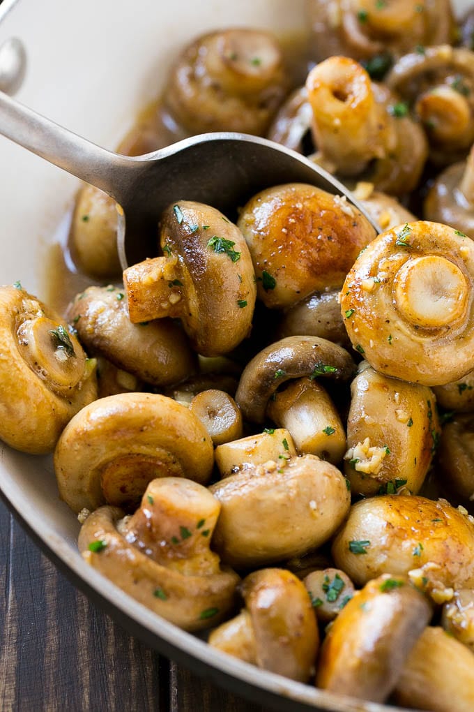 Garlic Mushrooms Recipe | Steakhouse Mushrooms | Sauteed Mushrooms | Garlic Butter Mushrooms | Mushroom Side Dish #mushrooms #butter #keto #lowcarb #dinner #sidedish #sadud A pan of sauteed garlic mushrooms with a serving spoon.