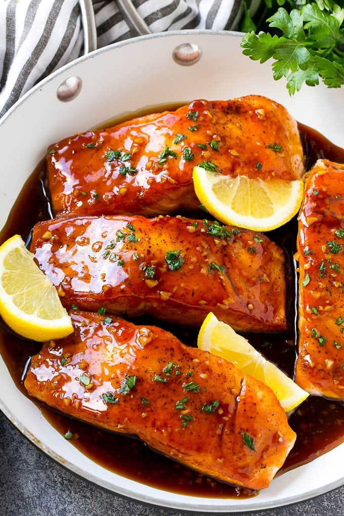 Honey Garlic Salmon Recipe | Asian Salmon Recipe | Healthy Salmon Recipe #salmon #fish #seafood #healthy #dinner #sadud A pan of honey garlic salmon topped with a savory sauce and garnished with parsley and lemon.