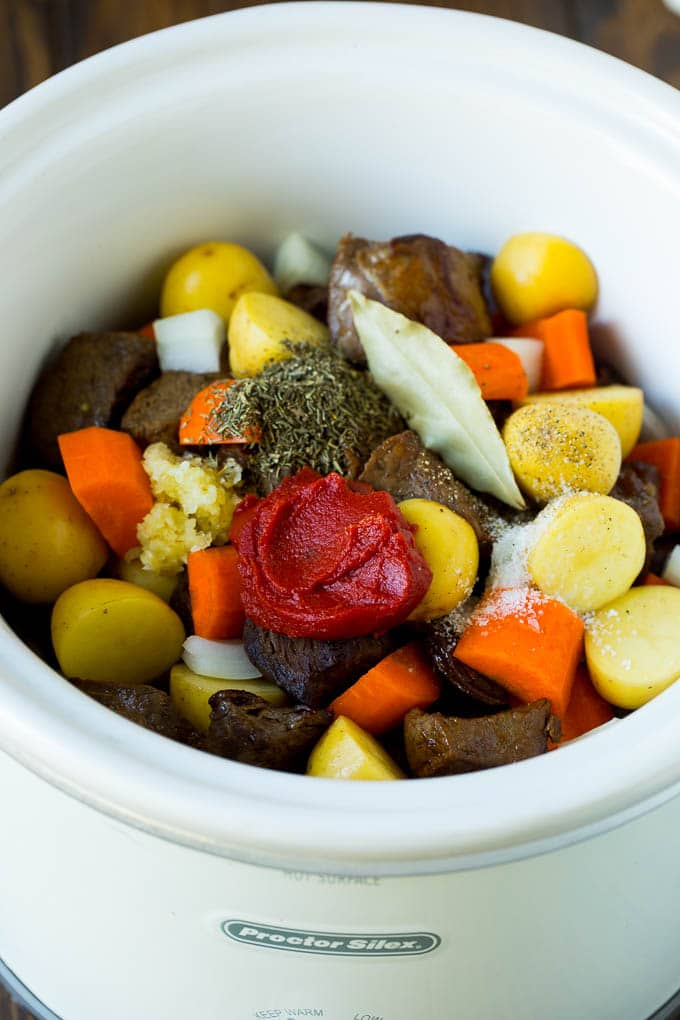 Slow Cooker Beef Stew Recipe | Crockpot Beef Stew #stew #soup #beef #slowcooker #crockpot #dinner #sadud A crock pot filled with beef, vegetables, tomato paste, herbs and spices.