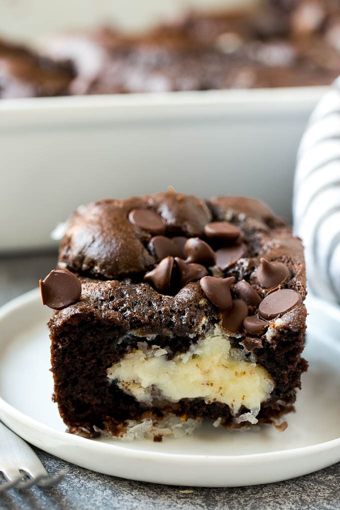 Earthquake Cake Recipe | Chocolate Cake Recipe | Chocolate Coconut Cake | Coconut Pecan Cake #cake #chocolate #coconut #pecans #dessert #chocolatecake #sadud A slice of earthquake cake on a plate.