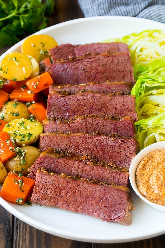 Slow Cooker Corned Beef Recipe | Crock Pot Corned Beef | Corned Beef and Cabbage #beef #cornedbeef #cabbage #potatoes #carrots #stpatricksday #irish #sadud A platter of slow cooker corned beef, cabbage wedges, potatoes and carrots.
