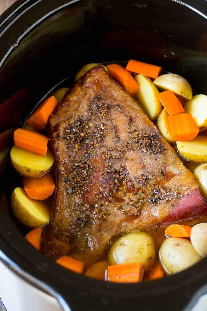 Slow Cooker Corned Beef Recipe | Crock Pot Corned Beef | Corned Beef and Cabbage #beef #cornedbeef #cabbage #potatoes #carrots #stpatricksday #irish #sadud A seasoned brisket with potatoes and carrots in a slow cooker.