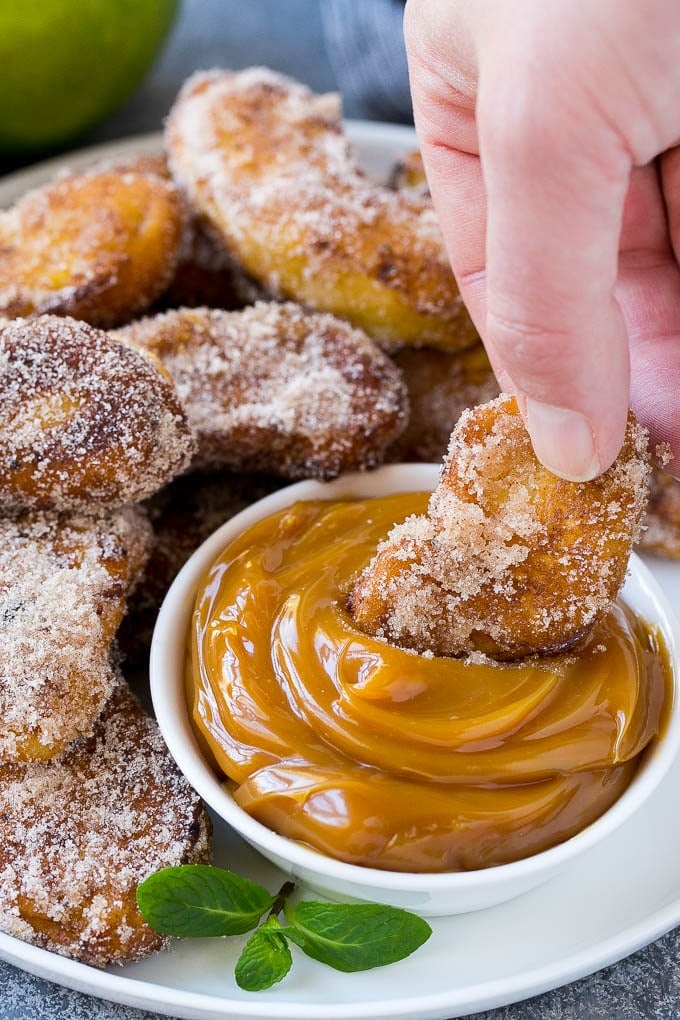 Apple Fries Recipe | Fried Apples Recipe | Cinnamon Sugar Apples | Apple Dessert Recipe #apples #dessert #sadud #fall An apple fry being dipped into caramel sauce.