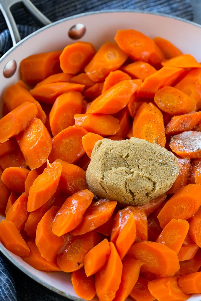 Candied Carrots Recipe | Carrot Side Dish | Brown Sugar Carrots | Glazed Carrots #carrots #brownsugar #sidedish #dinner #sadud Sliced carrots with butter, brown sugar and seasonings in a pan.