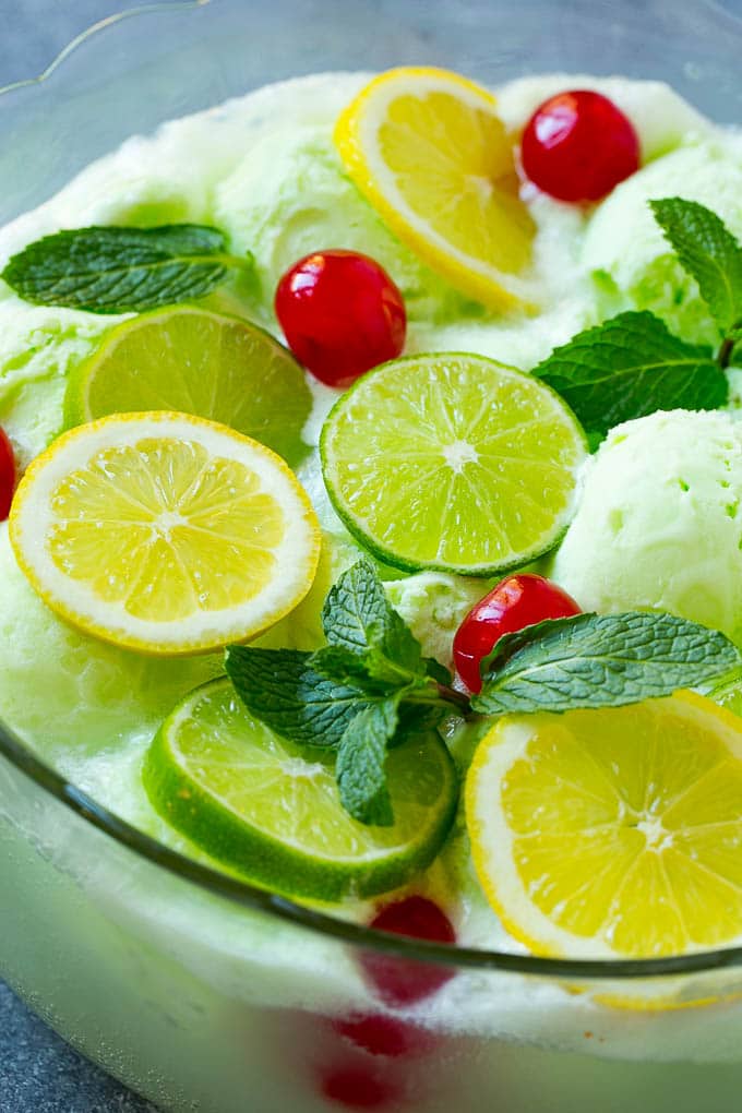 Lime Sherbet Punch | Party Punch Recipe | Sherbet Punch Recipe | Limeade Recipe #sherbet #punch #lime #drink #sadud A close up of a bowl of sherbet punch garnished with citrus and mint.