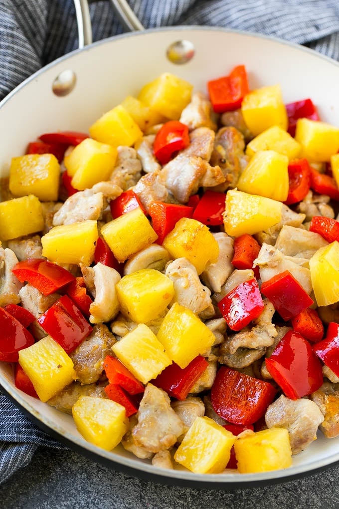 Pineapple Chicken | Hawaiian Chicken | Chicken Stir Fry #pineapple #chicken #dinner #stirfry #sadud A skillet of cooked chicken, pineapple and red bell peppers.