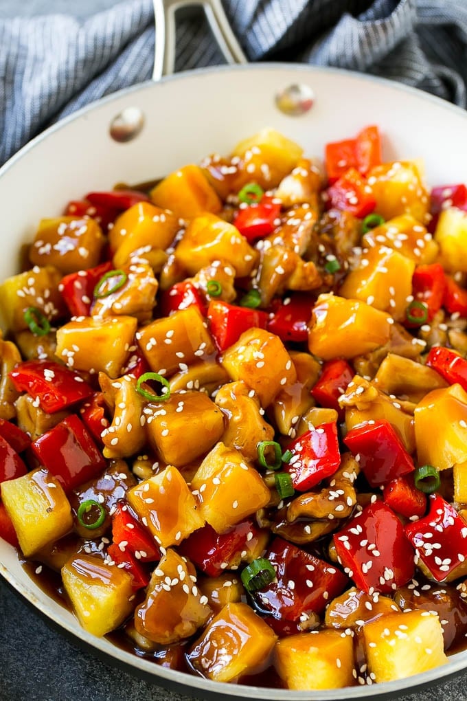 Pineapple Chicken | Hawaiian Chicken | Chicken Stir Fry #pineapple #chicken #dinner #stirfry #sadud Pineapple chicken stir fry in a skillet, topped with sauce, sesame seeds and green onions.