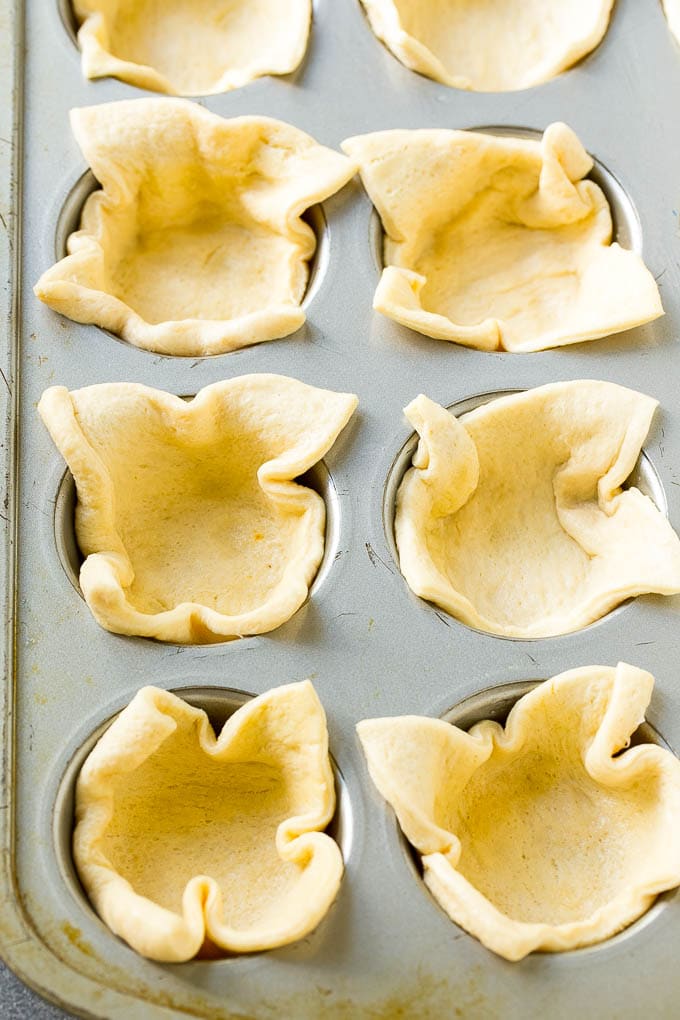 Pizza Muffins Recipe | Pizza Bites | Pizza Cups | Pizza Appetizer #pizza #appetizer #sadud Crescent roll dough pressed into a tin forms the crust.