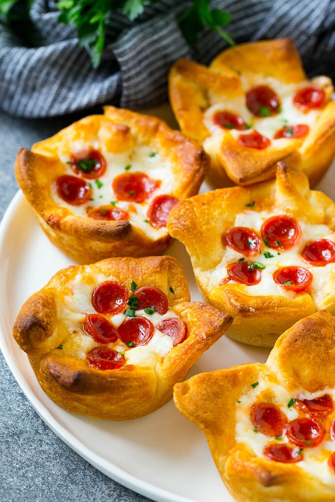 Pizza Muffins Recipe | Pizza Bites | Pizza Cups | Pizza Appetizer #pizza #appetizer #sadud A plate of pizza muffins made with crescent roll dough, pizza sauce, melted cheese and mini pepperoni.