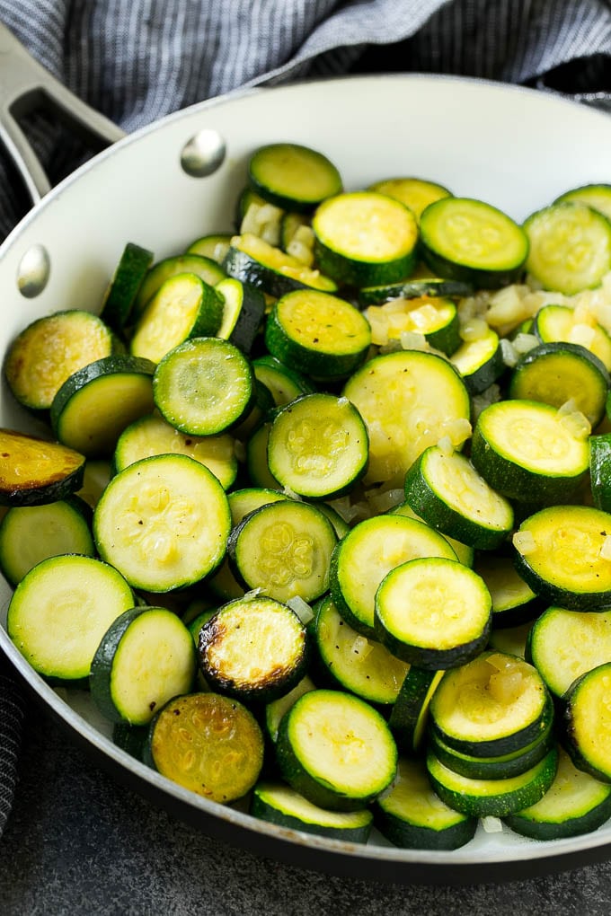 Zucchini Gratin Recipe | Cheesy Zucchini | Baked Zucchini | Easy Zucchini Recipe #zucchini #casserole #cheese #dinner #sidedish #sadud Sauteed zucchini and onions in a skillet.