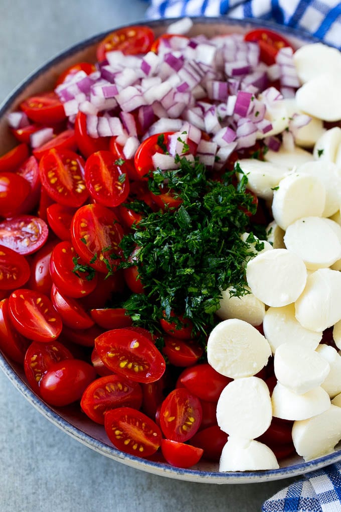 Cherry Tomato Salad Recipe | Tomato Mozzarella Salad | Caprese Salad | Tomato Salad #tomatoes #salad #tomatosalad #caprese #sadud A bowl of halved cherry tomatoes, mozzarella balls, herbs and minced red onion.