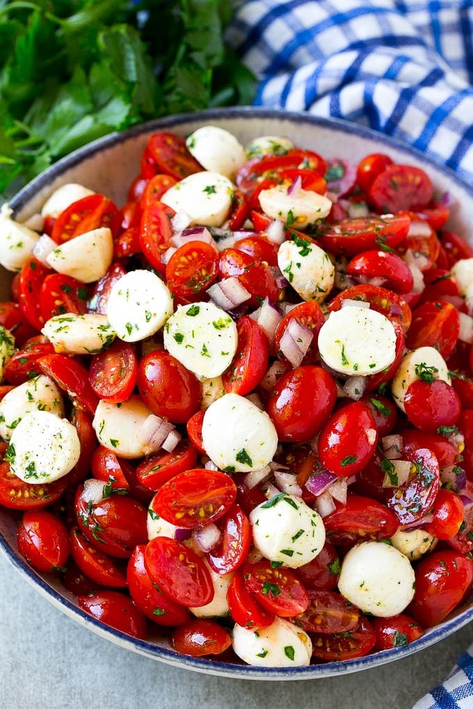 Cherry Tomato Salad Recipe | Tomato Mozzarella Salad | Caprese Salad | Tomato Salad #tomatoes #salad #tomatosalad #caprese #sadud A serving bowl of tomato mozzarella salad with cherry tomatoes, herbs and red onion.