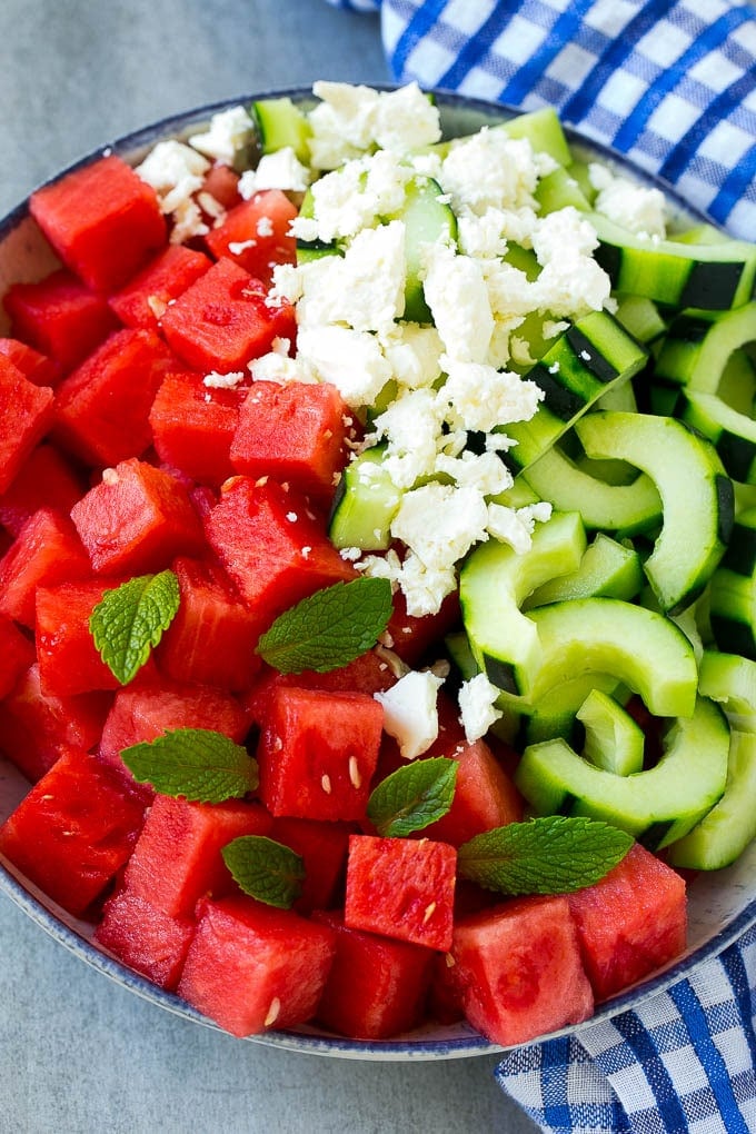 Watermelon Salad Recipe | Watermelon Feta Salad | Watermelon Cucumber Salad #watermelon #cucumber #salad #sadud A bowl of cubed watermelon, sliced cucumbers, feta cheese and mint leaves.