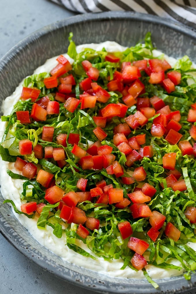 BLT Dip Recipe | Bacon Dip Recipe | Ranch Dip #dip #ranch #bacon #lettuce #tomato #appetizer #sadud Lettuce and tomatoes on top of ranch dip.