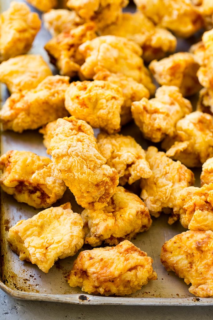 Sweet and Sour Chicken Recipe | Chinese Food Copycat Recipe | Chicken with Pineapple #chicken #chinesefood #pineapple #stirfry #takeout #dinner #sadud Fried pieces of chicken thighs on a sheet pan.