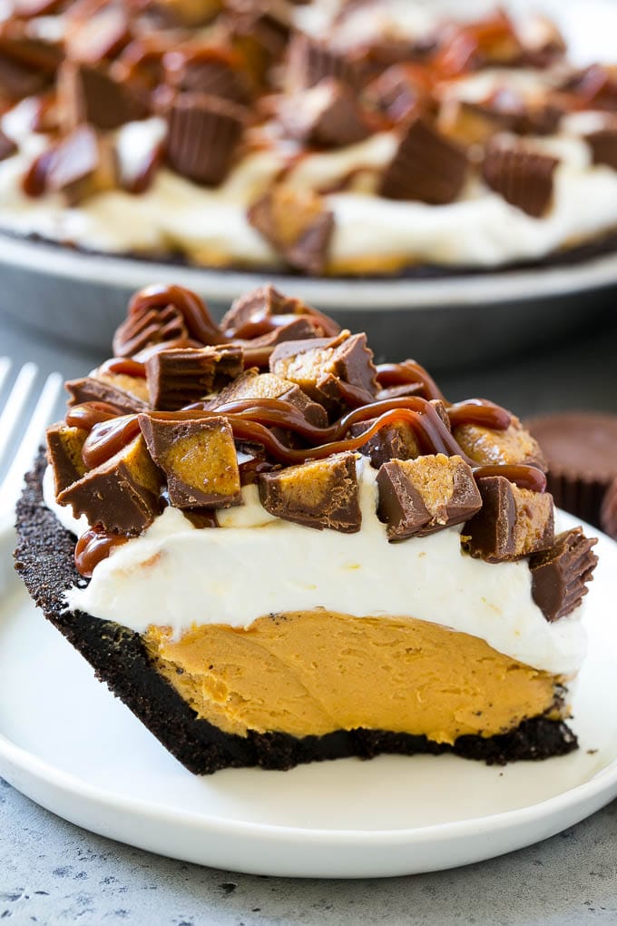 Chocolate Peanut Butter Pie Recipe | Peanut Butter Cup Pie | Peanut Butter Pie | No Bake Pie #chocolate #peanutbutter #pie #nobake #dessert #sadud A slice of chocolate peanut butter pie topped with whipped cream, chocolate sauce and peanut butter cups.