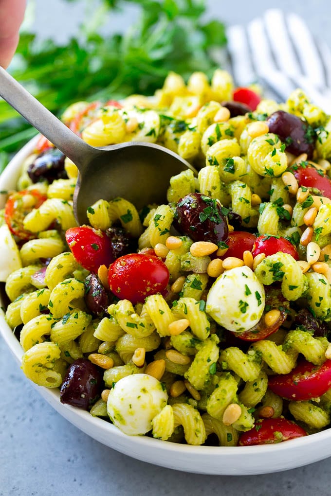 Pesto Pasta Salad | Italian Pasta Salad | Easy Pasta Salad #pasta #salad #pesto #olives #tomatoes #sadud Pesto pasta salad with cherry tomatoes, olives, mozzarella balls, pine nuts and red onion.