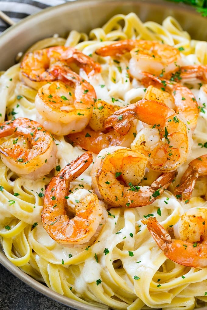 Shrimp Alfredo Recipe | Shrimp Alfredo Pasta | Shrimp Fettuccine Alfredo #shrimp #pasta #italianfood #sadud Shrimp alfredo in a skillet, topped with chopped parsley.