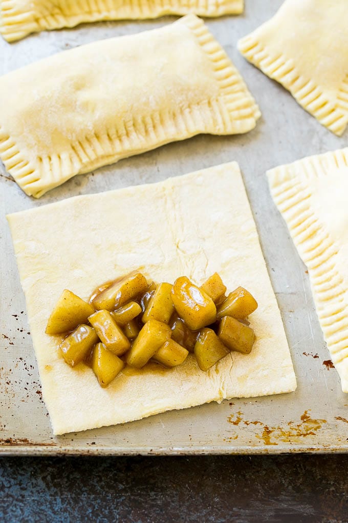 Fried Apple Pies Recipe | McDonald's Copycat Recipe | Apple Pie | Apple Hand Pies #pie #apples #applepie #dessert #snack #sadud A sheet of puff pastry topped with homemade apple pie filling.