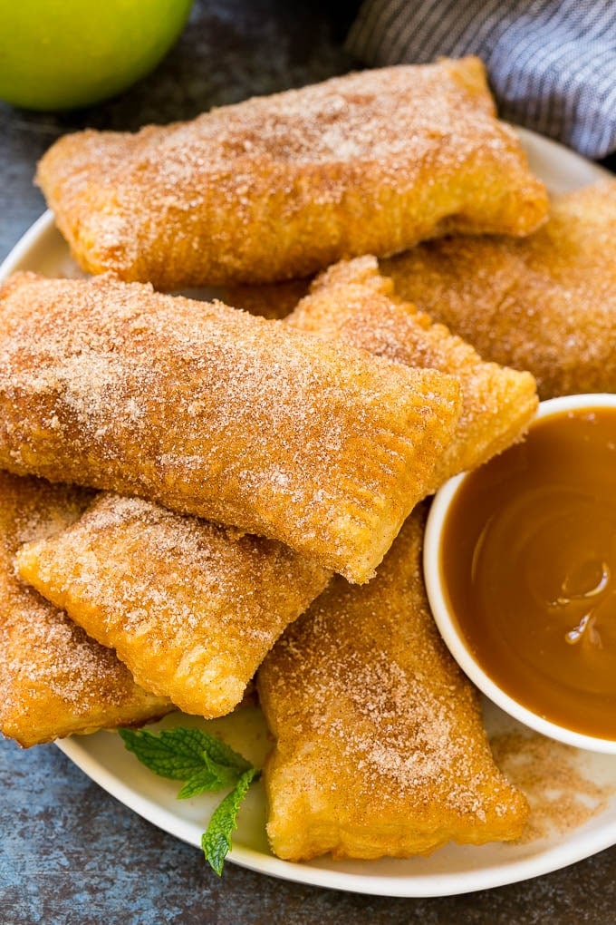 Fried Apple Pies Recipe | McDonald's Copycat Recipe | Apple Pie | Apple Hand Pies #pie #apples #applepie #dessert #snack #sadud A plate of deep fried apple pies dusted with cinnamon sugar.