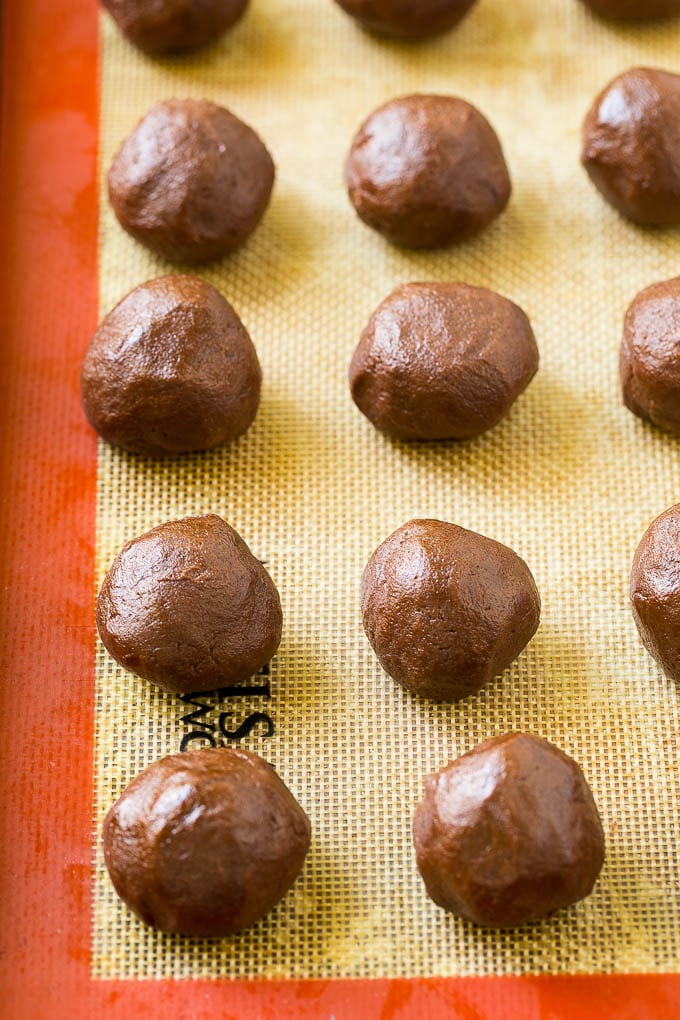 Nutella Cookies Recipe | Nutella Stuffed Cookies | Chocolate Cookies #nutella #chocolate #cookies #baking #dessert #sadud Balls of chocolate cookie dough on a baking sheet.