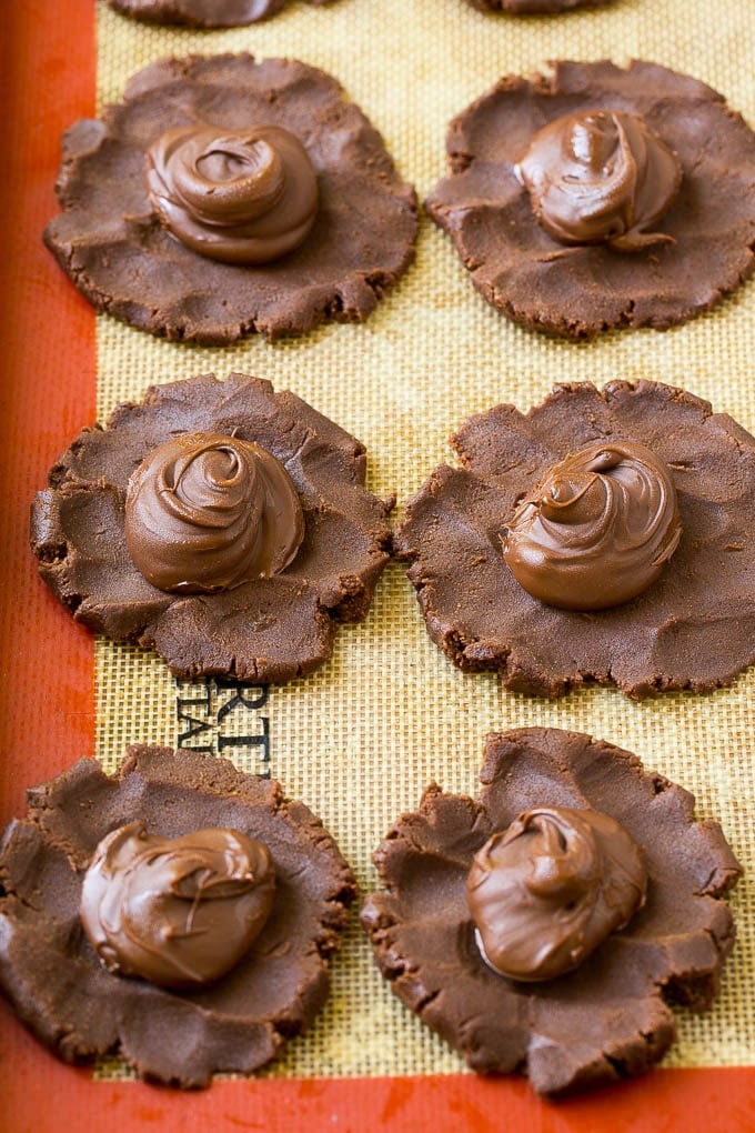 Nutella Cookies Recipe | Nutella Stuffed Cookies | Chocolate Cookies #nutella #chocolate #cookies #baking #dessert #sadud Cookie dough with dollops of nutella in the center.